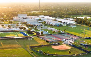 Sports facilities at public school in North Port, Florida. American football stadium, tennis court and baseball diamond sport infrastructure, cheap car insurance in Florida