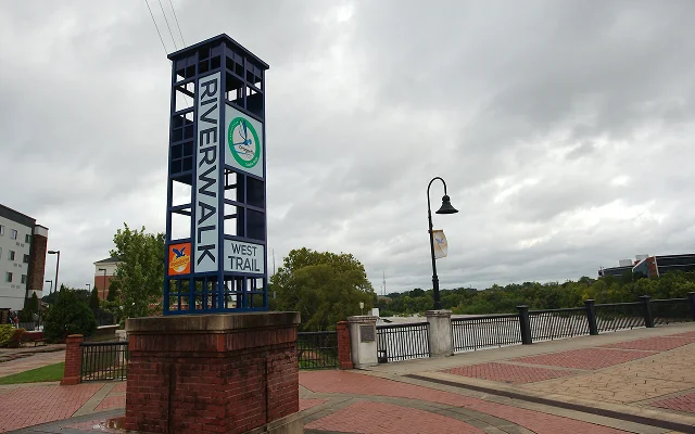 Signs at the Riverwalk. A walkway along the Chattahoochee River connecting to the city of Phenix City, Alabama – Phenix City, cheap car insurance in Alabama