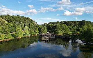 Aerial view of a lake in a forested landscape in Florence, Alabama. Cheap car insurance in Alabama.